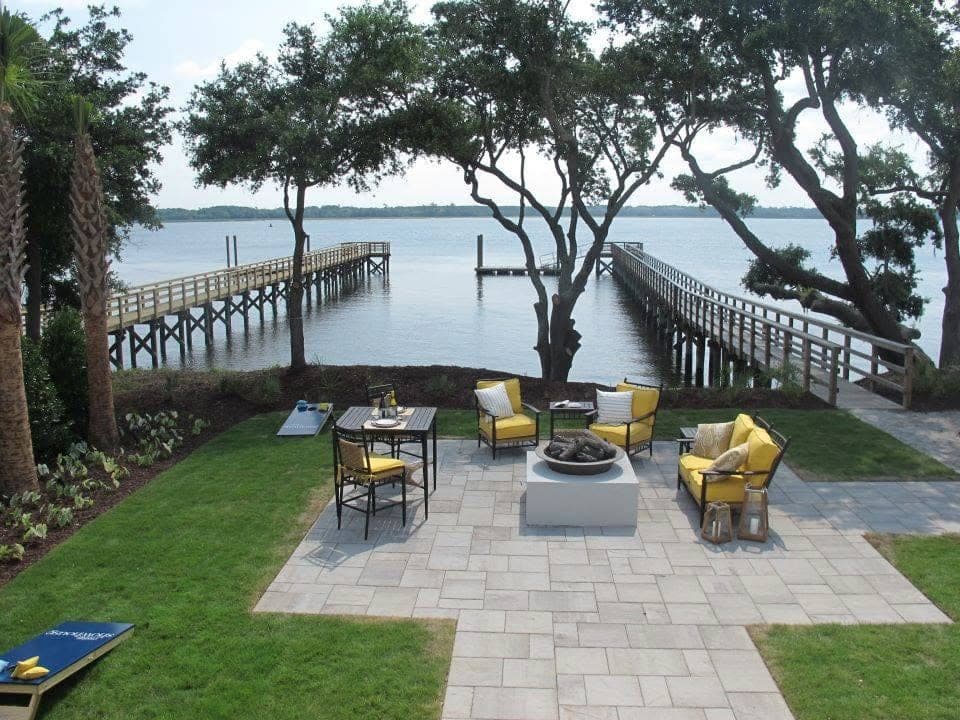 Paver sitting area overlooking the water, laid in a running-bond pattern with a soldier-course border